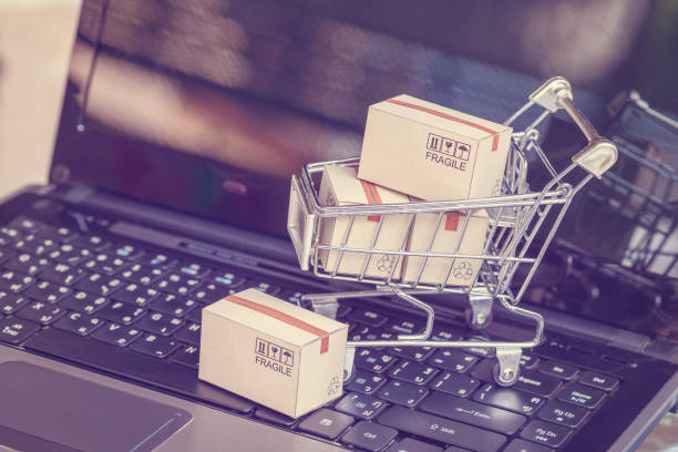 istock Boxes with shopping cart on a laptop computer keyboard 1220383338