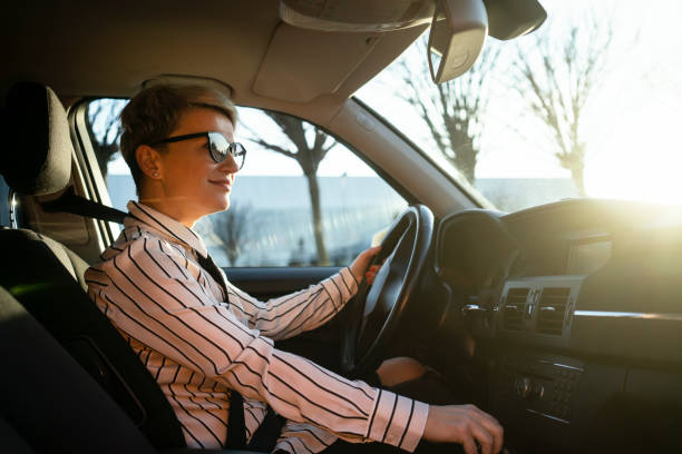 istock Smiling woman in a car 1220383593
