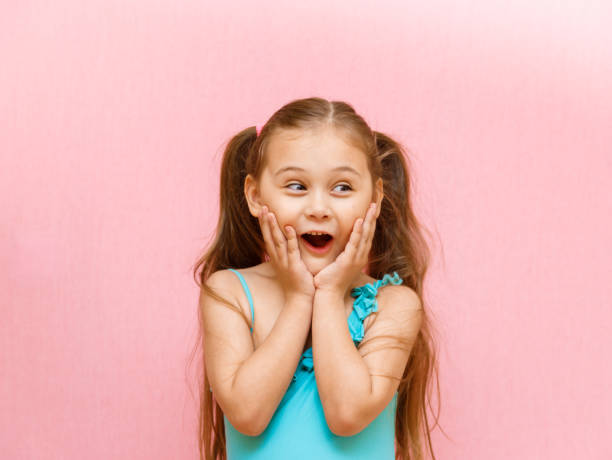 istock little girl with a surprised face on a pink background 1220384029
