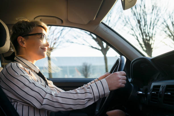 istock Smiling woman in a car 1220384057
