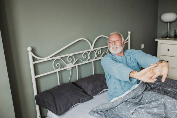 senior men waking up - quilt 60s 70s activity imagens e fotografias de stock