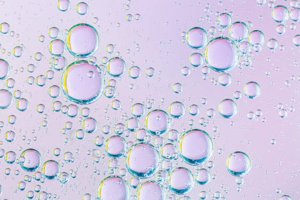 istock oil with bubbles on coral background. Pink Abstract space background. Soft selective focus. macro of oil drops on water surface. copy space. air bubbles in water, Banner format 1220385589
