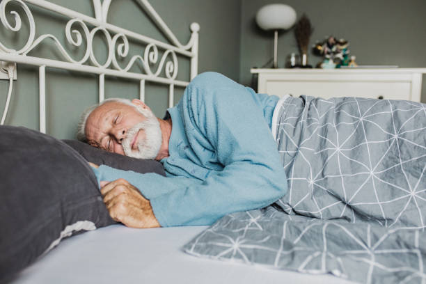 senior men waking up - quilt 60s 70s activity imagens e fotografias de stock