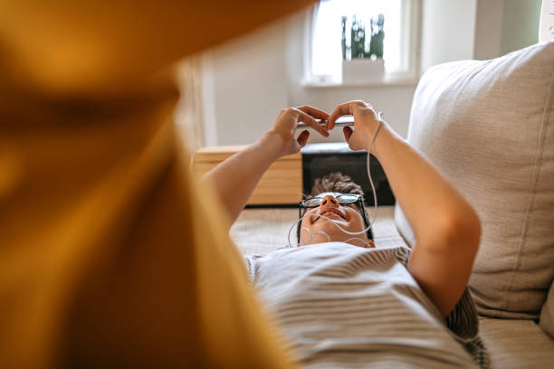 istock Teenager boy using smart phone at home 1220385845