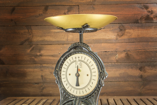 harvest of fruits from the orchard in the fall - rustic photo on a wooden background - quinces with vintage weighing scale