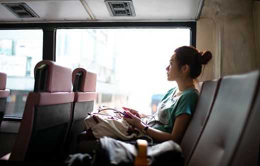 woman on the bus in hong kong look through window