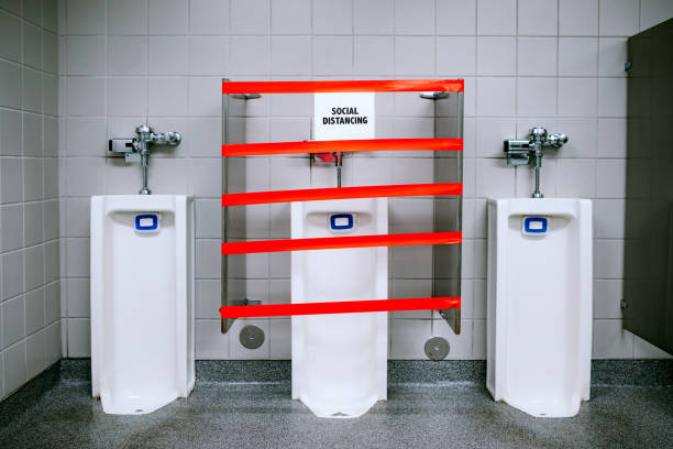 The restroom of an essential business has some of its toilets taped off to prevent people from standing too close during the Covid-19 virus outbreak. Shot in Washington State, USA.