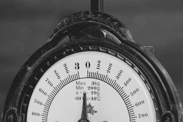 istock Vintage scale with brass and copper tray in a rustic still life with black and white pictured wood background 1220385957