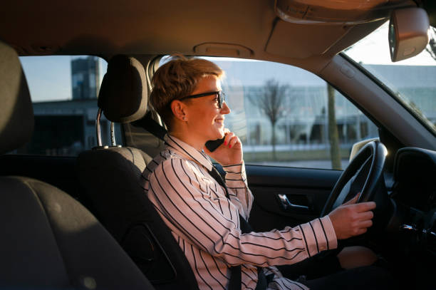 istock Smiling woman in a car 1220389717