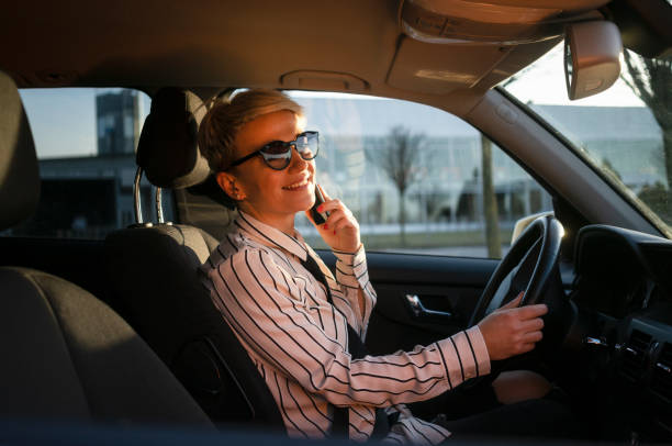 istock Smiling woman in a car 1220389718