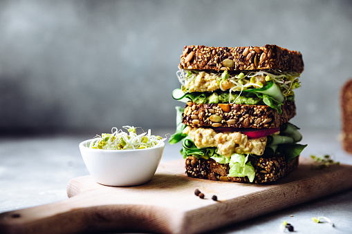 Vegan super sandwich served with sprouts