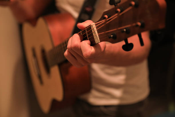 istock close up view of hands learning guitar 1220391896