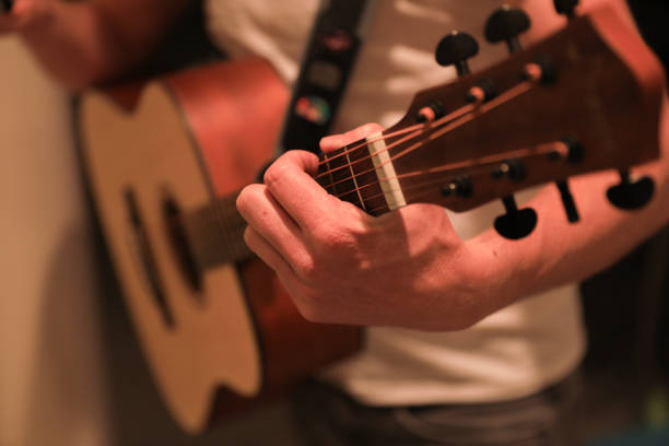 istock Hands playing a chord on a guitar close up 1220391910