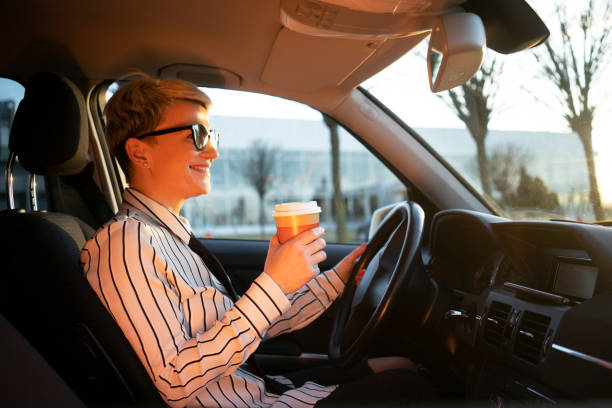 istock Smiling woman in a car 1220392896