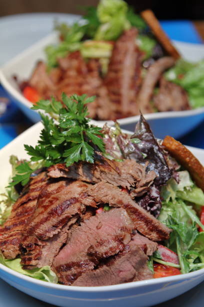 istock pieces of meat on salad 1220393267
