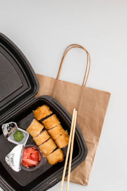 istock delivery service Japanese food rolls in plastic box. copy space 1220393407