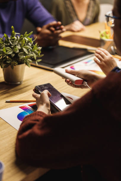 istock Charging up your smartphone during a team meeting in the office 1220393520