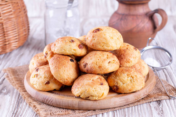 istock Homemade cottage cheese buns with raisins on a white table 1220393653