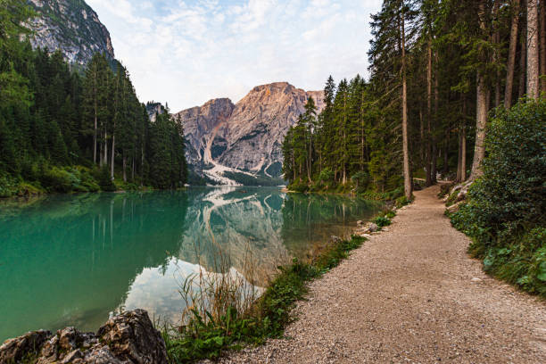 istock Dirt path runs along Lake Braies under a cloudy sky 1220396510