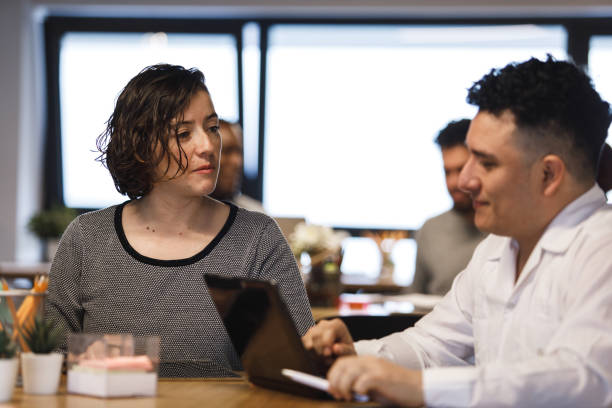 istock Coworkers writing a project report together 1220396534