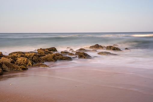 Smooth tidal flow on beach and rocks