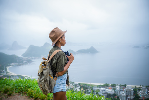 Shot of a young woman enjoying nature while  hiking