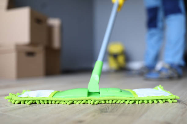 istock Man cleaning office, mopping floor from laminate 1220398804