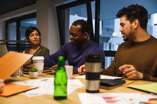 istock Multi-ethnic colleagues sitting by the table during graphic design meeting 1220398956