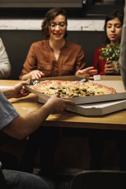 istock Pizza is a perfect late hours snack for these office employees 1220399875