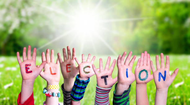 istock Children Hands Building Word Election, Grass Meadow 1220400577