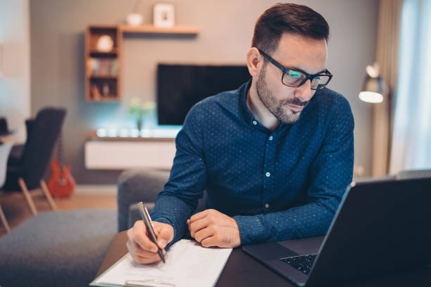 istock Overworked businessman late at home 1220400622