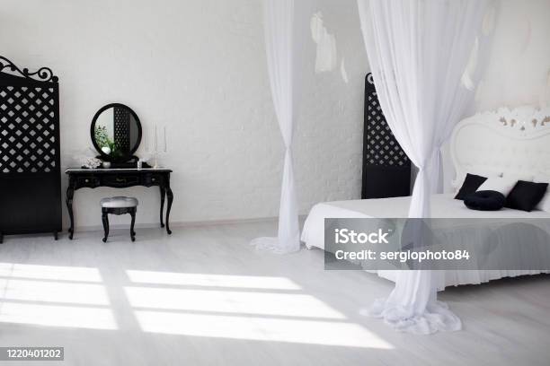 Cozy Bedroom Area At Luxury Studio Apartment With A Free Layout And Big Panoramic Window Stock Photo - Download Image Now