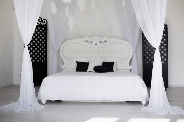 istock Cozy bedroom area at luxury studio apartment with a free layout and big panoramic window. 1220401227