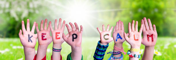 istock Kids Hands Holding Word Keep Calm, Grass Meadow 1220401550