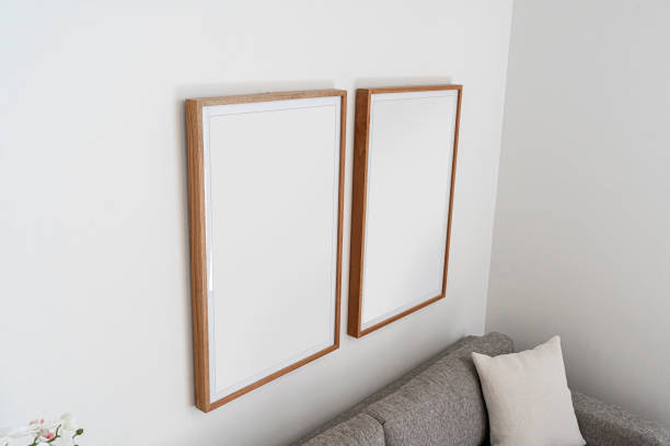 istock Interior decoration, empty wooden vertical frames, poster white canvas mock up on a white wall, living room template up angled view 1220401658