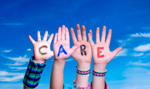istock Children Hands Building Word Care, Blue Sky 1220401713