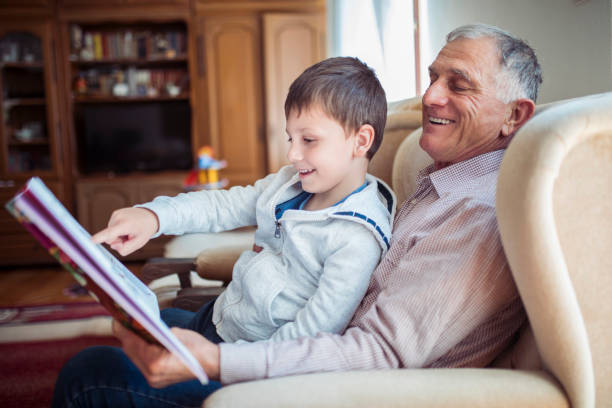 istock Grandfather reading with his grandson 1220402624