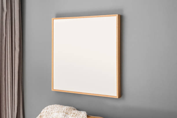 istock Interior decoration, empty wooden square frame, poster white canvas mock up on a gray wall, living room template angled view 1220403241