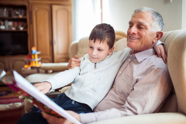 istock Grandfather reading books with his grandson 1220403585