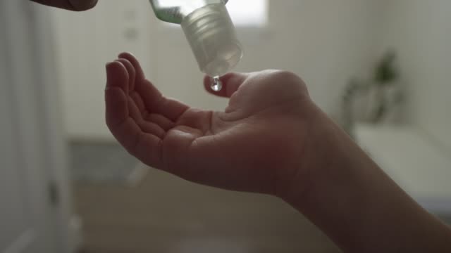 Close up squeezing hand sanitizer into child's hand