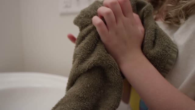 Close up of hands drying with a towel in slow motion
