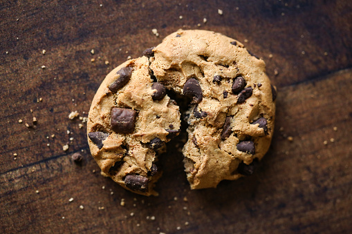 Chocolate chip cookies on a wooden blackground.