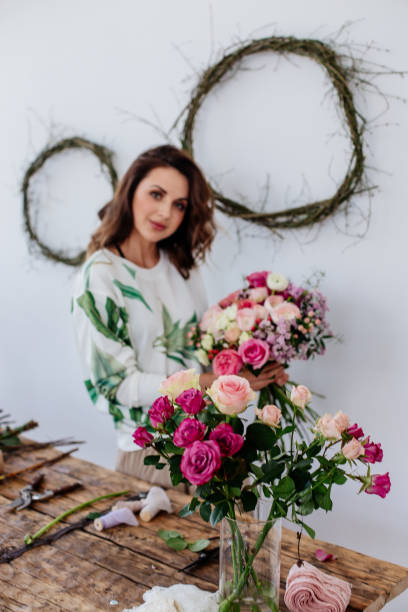 istock Florist makes a bouquet at light room. 1220404984