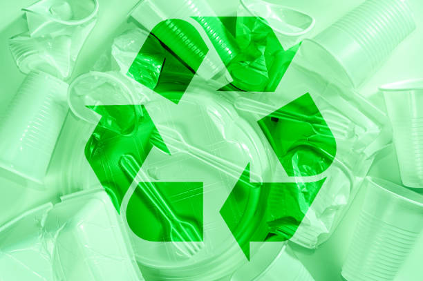 istock Disposable plastic tableware and recycling sign on a light background in green colors. Minimalistic ecologically clean still life. Pop Art. And ecology problem concept. 1220405349