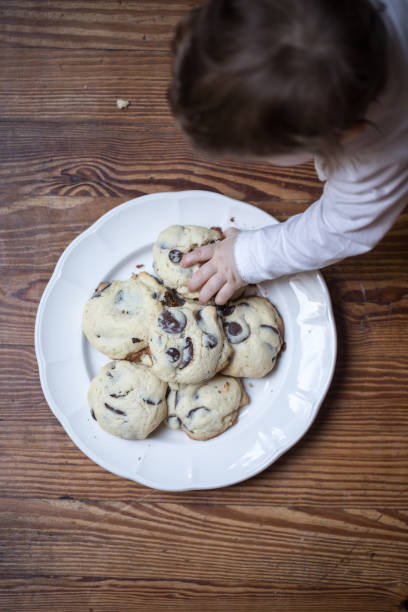istock Baby grabbing a cookie from the plate 1220406571