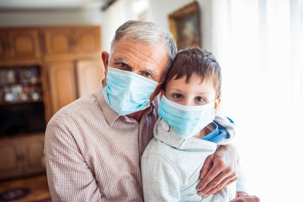 Portrait of grandfather and grandson with face mask Portrait of grandfather and grandson with face mask at home grandson photos stock pictures, royalty-free photos & images