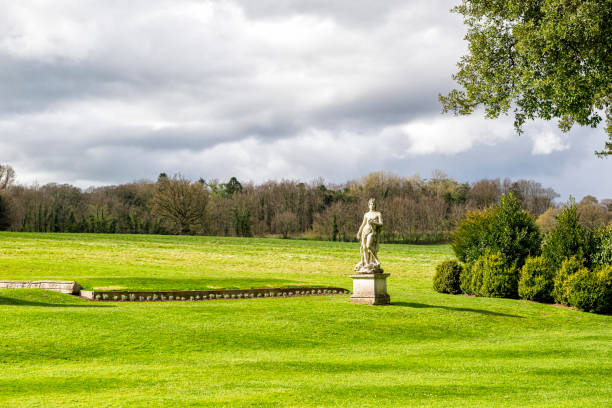 istock Green Fields with Art Deco Greek Statue on Lawn 1220406963