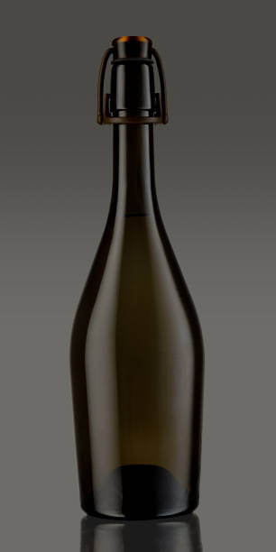 Unlabeled bottle of sparkling wine, with swing top closure, isolated on dark grey background, clipping path included.