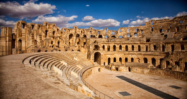 The impressive ruins of the largest colosseum in North Africa, a huge Roman amphitheater in the small village of El Jem, Tunisia. UNESCO World Heritage Site The impressive ruins of the largest colosseum in North Africa, a huge Roman amphitheater in the small village of El Jem, Tunisia. UNESCO World Heritage Site amphitheater stock pictures, royalty-free photos & images