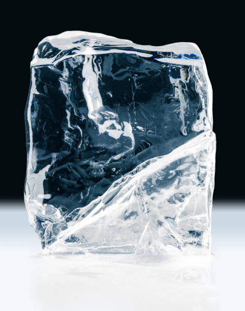 istock Crystal clear, textured, natural ice block, on  black background. Clipping path included. 1220408796